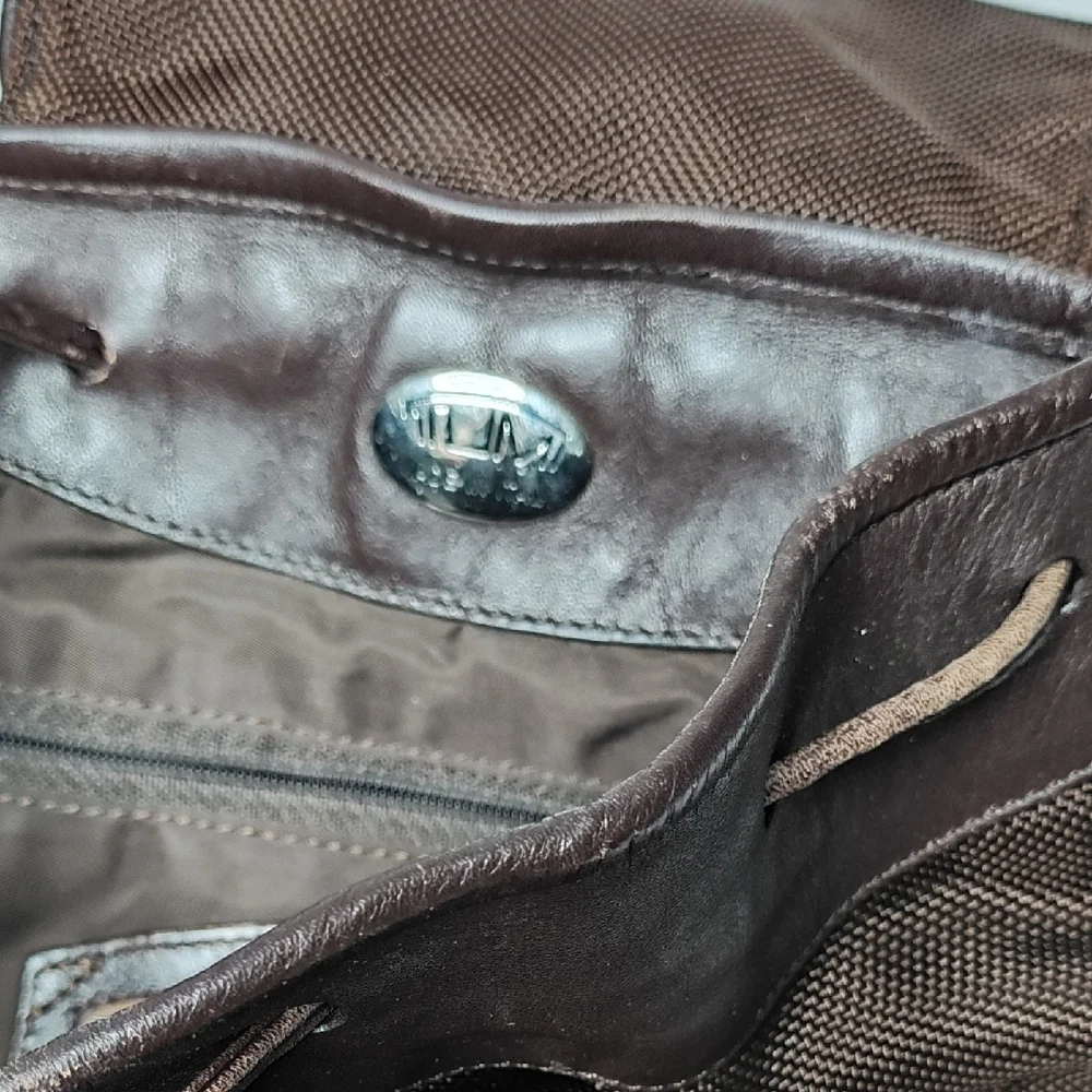 Tumi Italian Leather Drawstring Backpack Sling